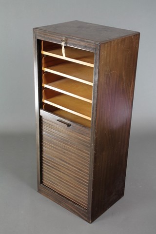 A 1930's filing cabinet, the interior fitted 9 trays enclosed by a tambour shutter 43"h x 18"w x 14"d 