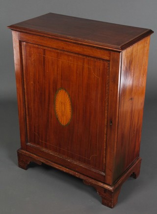 A Victorian inlaid mahogany Pier cabinet with crossbanded inlaid top, fitted shelves enclosed by a panelled door with shell motif to the centre and raised on cabriole supports 35"h x 26 1/2"w x 14"d