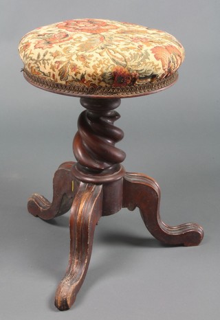 A Victorian mahogany adjustable piano stool with spiral turned column and tripod base 