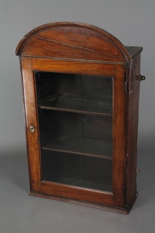 An 18th Century oak hanging cabinet with arch shaped cornice, fitted shelves enclosed by a panelled mirrored door 42"h x 25"w x 9 1/2"d 
