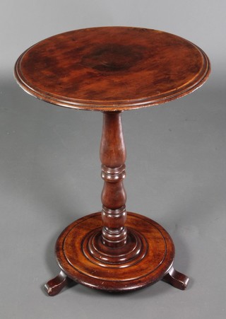 A Victorian circular mahogany occasional table raised on a turned column and circular base with scroll feet 28" x 20" 