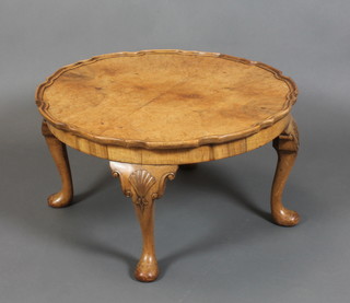 A Queen Anne style circular figured walnut coffee table with quarter veneered top and pie crust edge, raised on cabriole supports 15"h x 27" diam. 