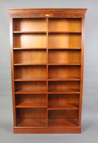 A Georgian style mahogany bookcase with moulded and dentil cornice fitted adjustable shelves, raised on a platform base 84 1/2"h x 51" 1/2 x 15"d 