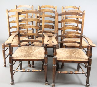 A set of 8 Georgian style elm Lancashire back ladder dining chairs with woven rush seats, 2 with arms 
