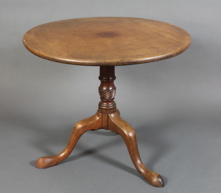 A George III circular mahogany snap top tea table, raised on a turned gun barrel column with tripod base 24"h x 28 1/2" diam. 