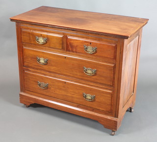 An Edwardian Art Nouveau walnut chest of 2 short and 2 long drawers, raised on a platform base 32 1/2"h x 29"w x 19"d 