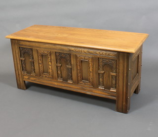 A carved oak coffer of panelled construction with hinged lid 20"h x 45"w x 17 1/2"d