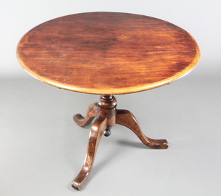 A 19th Century circular stained pine snap top tea table, raised on pillar and tripod support 27"h x 35" diam. 
