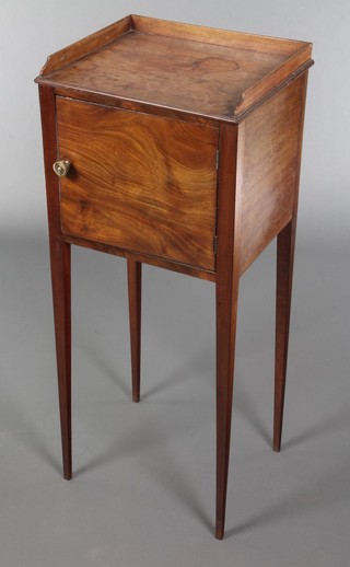 A Georgian mahogany pot cupboard with three-quarter gallery, enclosed by panelled doors, raised on square tapering supports 34"h x 14"w x 12"d 