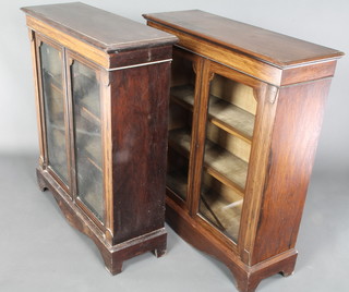 A pair of Victorian inlaid rosewood display cabinets with inlaid satinwood stringing, fitted shelves enclosed by glazed panelled doors, raised on bracket feet 41"h x 36"w x 12"d 