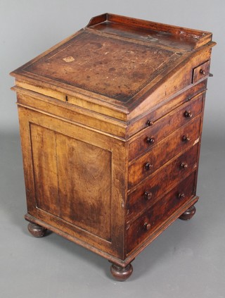 A Regency mahogany sliding top Davenport desk, with three-quarter gallery fitted an inkwell drawer above a brushing slide and 4 long drawers, raised on bun feet 33"h x 21"w x 23"d 