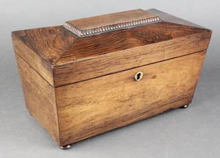 A Regency rosewood twin compartment tea caddy of sarcophagus form with mixing/sugar bowl, raised on bun feet 5 1/2"h x 10 1/2"w x 6 1/2"d 
