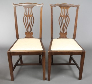 A pair of Chippendale style mahogany dining chairs with pierced vase shaped slat backs and upholstered drop in seats, on square tapering supports with H framed stretchers 