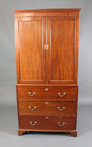 An Edwardian mahogany linen press with moulded cornice enclosed by panelled doors (no trays), the base fitted 3 long drawers with brass swan neck drop handles, raised on bracket feet 77"h x 37 1/2"w x 23"d 