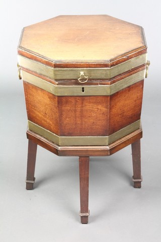 A Regency octagonal mahogany and brass banded cellarette with brass drop handles to the sides, raised on 4 tapered supports ending in spade feet 26"h x 17"w x 17"d 