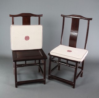 A pair of Chinese Padouk wood slat back chairs with solid seats, raised on turned supports with box framed stretchers 