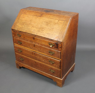 A Georgian oak bureau, the fall front revealing a well fitted interior above 4 long graduated drawers with brass swan neck drop handles, raised on bracket feet 41"h x 37"w x 20"d