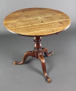 A circular elm snap top tea table, the top formed of 3 planks raised on a turned column and tripod base 28"h x 30 1/2" diam. 