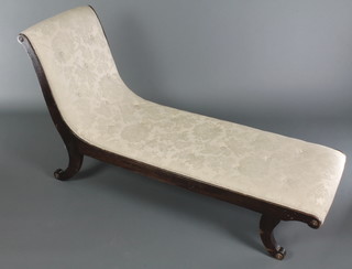 A 19th Century mahogany show frame chaise longue upholstered in white buttoned material, raised on scroll supports 