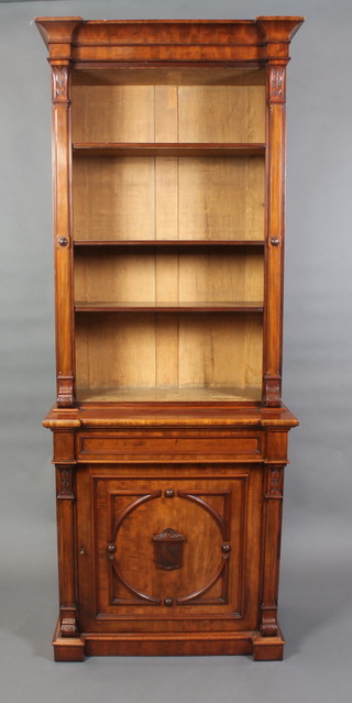 A Victorian mahogany bookcase on cabinet with moulded cornice, fitted adjustable shelves and with columns to the sides, the base fitted 1 long drawer above cupboard enclosed by a panelled door with shield to the centre 88"h x 32 1/2"w x 17"d 