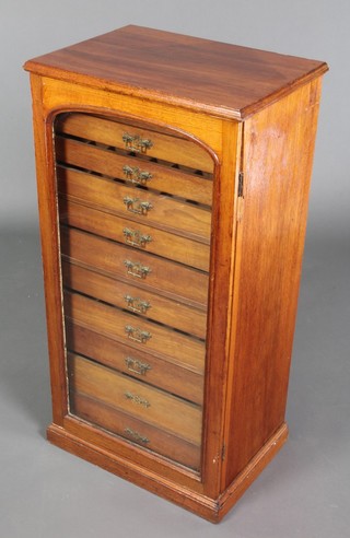 A Victorian mahogany collector's chest of 11 shallow drawers enclosed by an arched glazed panelled door, raised on a platform base 37"h x 19"w x 14"d 