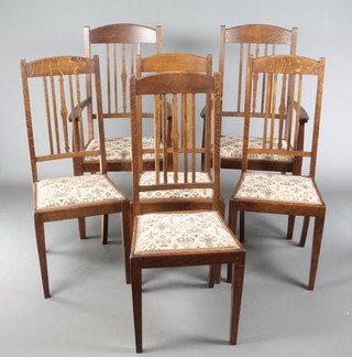 A set of 6 oak Art Nouveau Voysey style dining chairs, 2 with arms, raised on square tapering supports with tapestry seats 