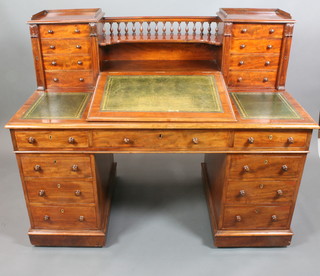 A Victorian mahogany Dickens desk, the raised superstructure with three-quarter gallery and recess flanked by a pair of pedestals fitted 8 short drawers above green leather writing surface, the base fitted 1 long and 8 short drawers 48"h x 60"w x 31"d 