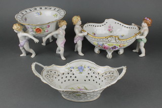 A 20th Century Plaue centrepiece, the pierced bowl supported by 3 cherubs 7", a ditto oval centre piece 15" and a twin handled basket 11" 