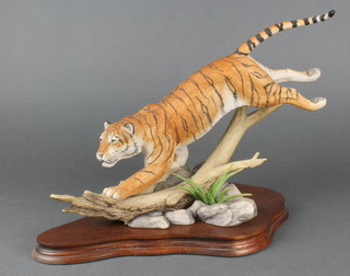 A Border Fine Arts composition figure of a tigress on a branch, on a wooden base 17" 