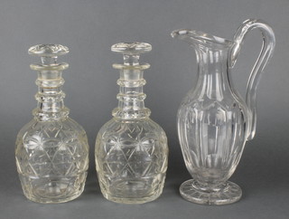 A pair of 19th Century mallet shaped decanters with ring necks and mushroom stoppers 10",  a 19th Century faceted jug 11" 