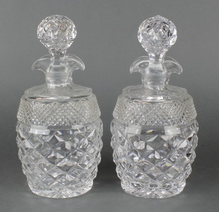 A pair of cut glass barrel shaped hobnail cut double lipped decanters and stoppers 10" 