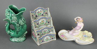 A Plaue Art Nouveau style dish in the form of a lady looking in a hand mirror 9", a Continental 4 section letter rack decorated with flowers 8" and a green glazed fish gurgle jug 9" 