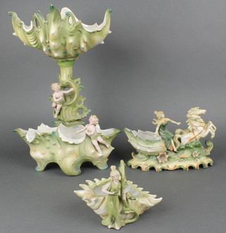 A Victorian biscuit porcelain table centrepiece in the form of a shell supported by figures and surmounted by a shell 15", a similar vase in the form of a chariot 8" and 1 other shell shaped vase 6" 