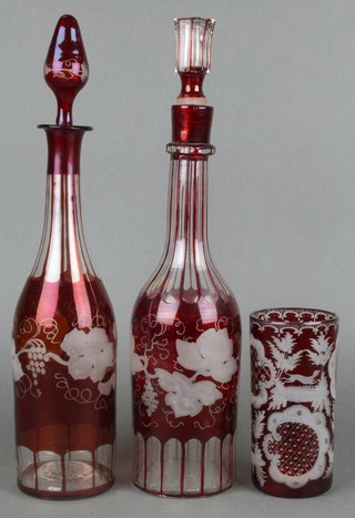 A Bohemian red overlay glass decanter and stopper decorated vinery 14", 1 other 14" together with a similar beaker 5" 