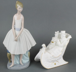 A Nao figure of a standing girl in long dress by a stool 12", a Brooks & Bentley biscuit porcelain figure group of a couple sitting in a sleigh 5 1/2" 