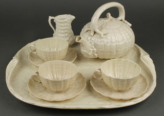 A Belleek 3 piece cabaret set with tray 15", circular teapot (crack to spout), cup and saucer, all with black Belleek mark together with 2 similar cups and saucers and jug (chips to spout) 