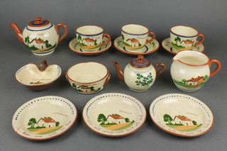 A 14 piece Motto Ware tea service comprising 2 teapots 4" and 2 1/2", milk jug, twin handled sugar bowl, shaped butter dish, 3 plates, 3 cups and 3 saucers (cracked) 