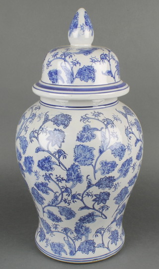 A Chinese blue and white urn and cover with floral decoration 19" 