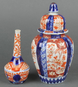 A 19th Century Imari bulbous vase with high dome cover decorated with panels of trees 7", a ditto bottle vase 4 1/2" 