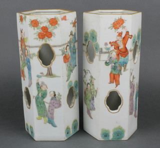 A pair of late 19th Century octagonal Chinese vases with pierced quatrefoil sides decorated with figures at pursuits, bearing an 8 character mark to base 11" 