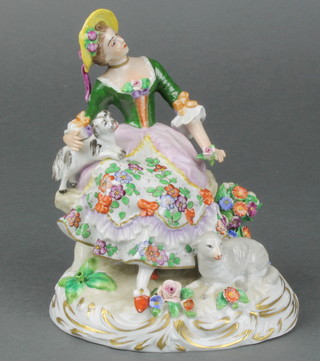 An early 20th Century Sitzendorf figure of a seated shepherdess with a dog on her lap on a rococo base 6 1/2" 