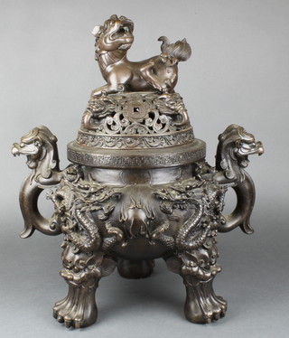 A 19th Century Japanese pierced bronze koro with 2 dragon handles, the finial in the form of a seated Dog of Fo and the body decorated dragons, raised on 4 paw feet 21"h, with seal mark to the base 
