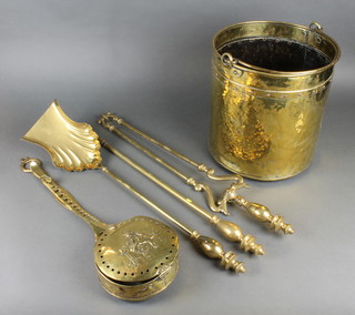A Georgian style brass 3 piece fireside companion set comprising poker, tongs and shovel together with a chestnut roaster decorated a seated figure of Toby Philpots (hole to lid) and a cylindrical brass coal bin 