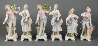 6 early 20th Century German porcelain figures of ladies and gentleman carrying fruits and flowers on raised rococo bases 7" 