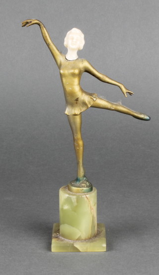 An Art Deco spelter figure of a dancing girl with carved ivory head, raised on a turned onyx base 8" 