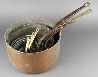 A copper saucepan with brass handle, 4 19th Century circular copper saucepans with iron handles 10", 8", 7" and 6", together with 5 reproduction copper saucepans with brass handles 4", 3 1/2", 3",  2 1/2" and 2"  