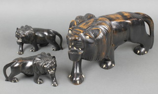 A carved ebony figure of a walking lion 8" together with 2 other carved ebony figures of walking lions 2" (1 eye missing and some teeth) 