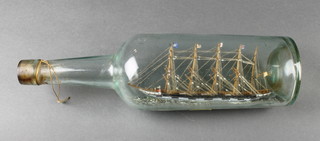 An Edwardian ship in a bottle of a 4 masted British Merchant clipper, the base with label marked  Lymington 1908