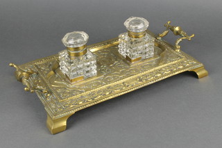 A Victorian brass and glass twin handled 2 bottle inkwell with 2 cut glass square bottles on ogee bracket feet 13"  
