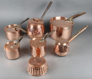 A Benham circular copper spouted saucepan with turned wooden handle and an associated lid 4", a circular Benham & Sons of Wigmore Street a circular copper saucepan and lid with iron handle 5" and 4 other saucepans with lids 10", 6 1/2", 7" (handle to lid if f), 6" together with a circular copper mould 6 1/2"